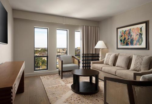 a living room with a couch and a table at Plaza San Antonio Hotel & Spa, Autograph Collection in San Antonio