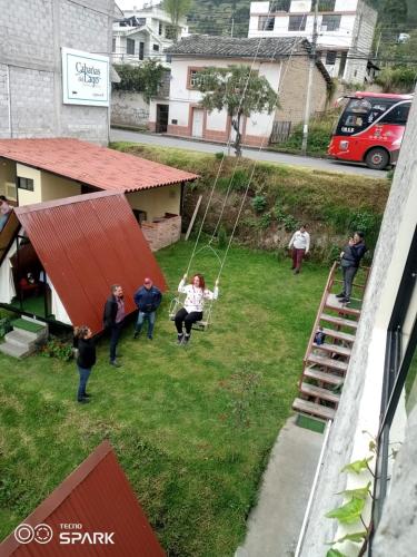 a group of people on a swing in a yard at Hospedaje Campo Lago y Glamping in Otavalo