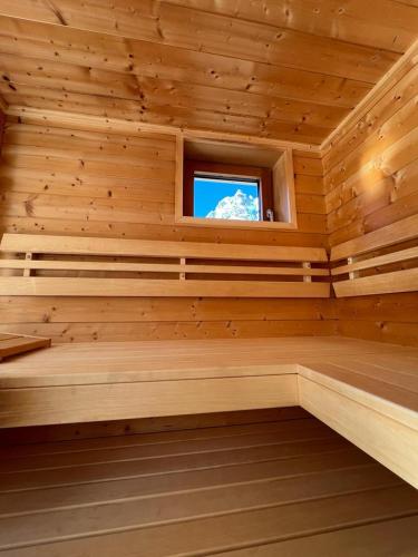 a wooden room with a sauna with a window at Wetterstein-Chalet in Leutasch