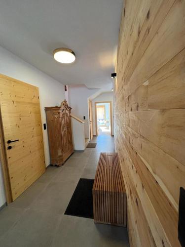 a hallway with a wooden wall and a bench at Wetterstein-Chalet in Leutasch