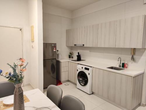 a kitchen with a washing machine and a sink at SKS PAVILLION Cozy Studio With Netflix WiFi Car Park in Johor Bahru