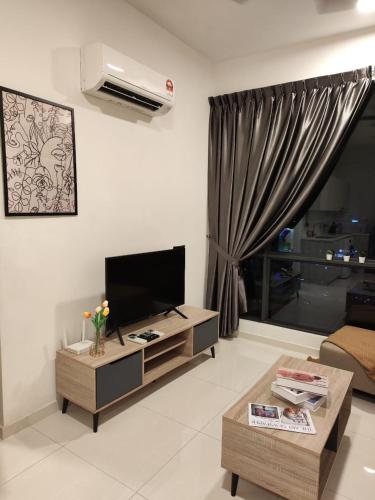 a living room with a tv and a couch at SKS PAVILLION Cozy Studio With Netflix WiFi Car Park in Johor Bahru