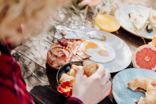 a person eating food on a table with plates of food at Bed and Breakfast Kolo Adults only in Novigrad Istria