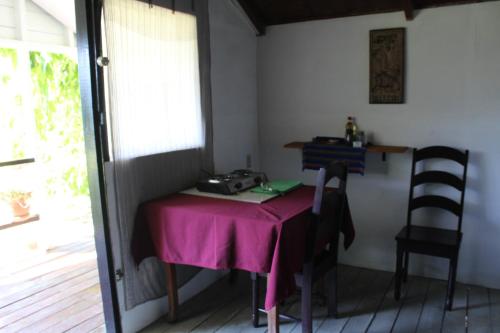 a small table with a pink table cloth on it at Nabitunich in San Ignacio