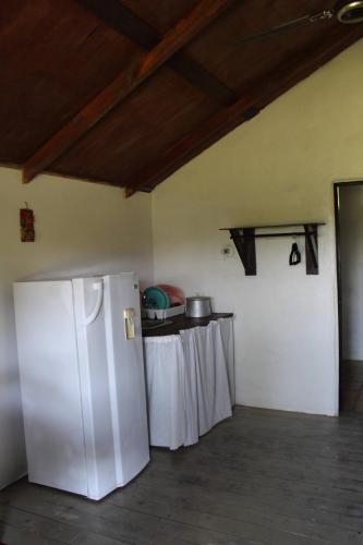 a kitchen with a white refrigerator and a table at Nabitunich in San Ignacio
