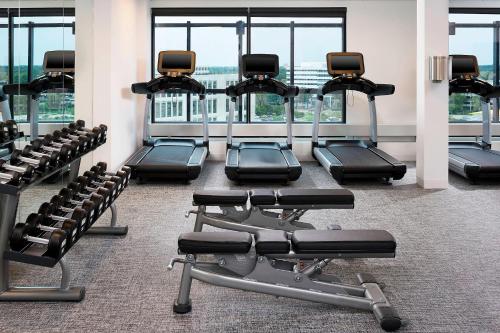 a gym with rows of treadmills and exercise machines at Le Méridien Chicago - Oakbrook Center in Oak Brook