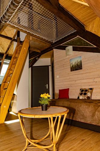 a table and a couch in a living room at Gîte Les Sabots de Paille, Alsace Haut-Rhin in Ballersdorf