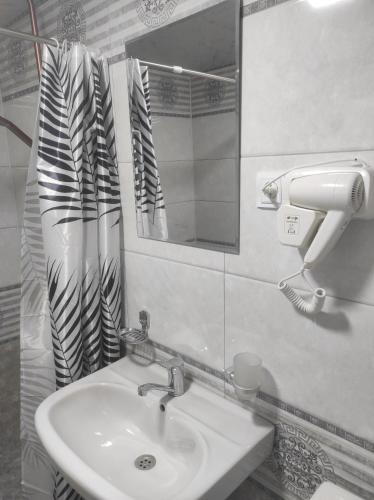 a bathroom with a sink and a mirror at Old Street Khiva in Khiva