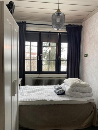 a bedroom with a bed and a window at Villa Lyckan in Söråker