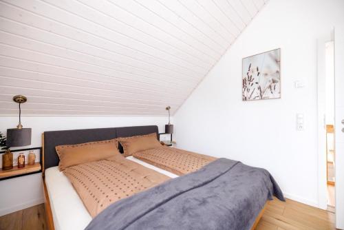 een bed in een kamer met witte muren bij Vechteufer in Nordhorn