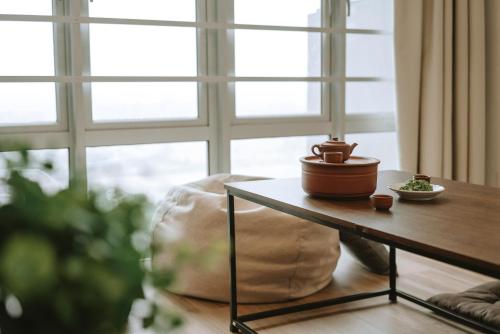 a coffee table with a potted plant on it next to a window at Mount Austin Manhanttan Sovo by Cactus Homestay in Johor Bahru
