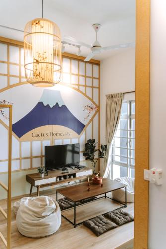 a living room with a tv and a table at Mount Austin Manhanttan Sovo by Cactus Homestay in Johor Bahru