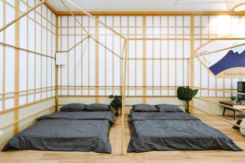two beds in a room with yellow walls at Mount Austin Manhanttan Sovo by Cactus Homestay in Johor Bahru
