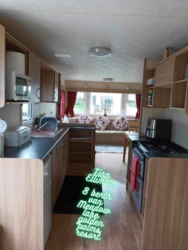 an rv kitchen with a stove and a couch at Tina's caravan hire in Chapel Saint Leonards