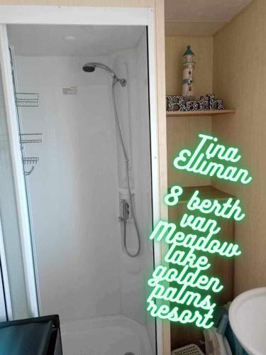 a bathroom with a shower with a sign on the door at Tina's caravan hire in Chapel Saint Leonards