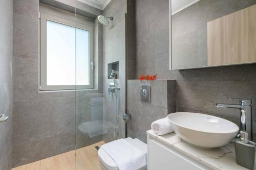 a bathroom with a sink and a glass shower at Villa Panaxia Kohille in Theologos