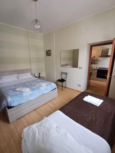 a bedroom with two beds and a mirror at Apartment L'aquila in LʼAquila
