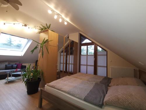 a bedroom with a bed in a attic at Studio und Apartment auf dem Pferdehof in Burgpreppach
