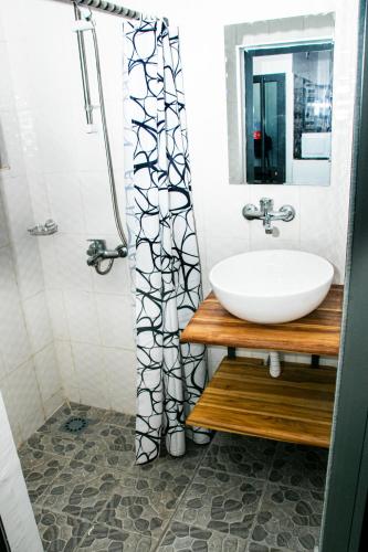 a bathroom with a sink and a mirror at les perles du bonheur Nyékonakpoé in Lomé