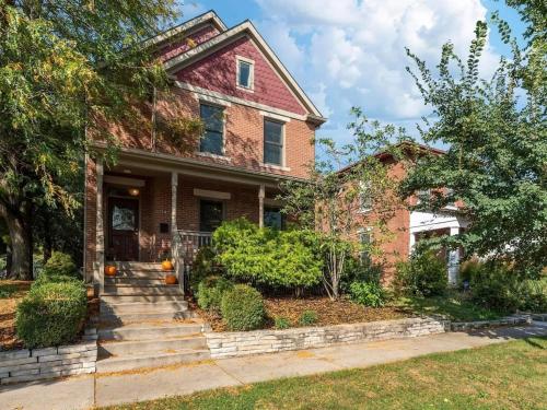 an old brick house with a staircase in front at Housepitality - The Victorian Vacation Home in Columbus