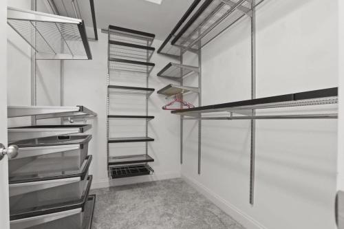 a walk in closet with metal shelving at Housepitality - The Victorian Vacation Home in Columbus