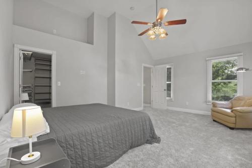 a bedroom with a bed and a ceiling fan at Housepitality - The Victorian Vacation Home in Columbus