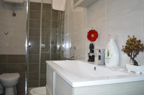 a bathroom with a white sink and a toilet at Apartment L'aquila in LʼAquila