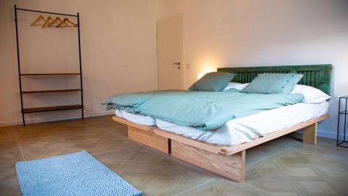 a bedroom with a large bed with a wooden frame at Casa Gatti BnB Gastronomia e Benessere in Motto