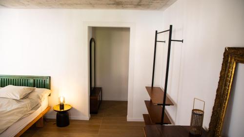 a bedroom with a bed and a mirror at Casa Gatti BnB Gastronomia e Benessere in Motto
