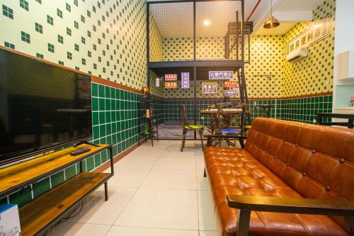 a waiting room with a leather couch in a restaurant at Mount Austin Manhanttan Sovo by Cactus Homestay in Johor Bahru