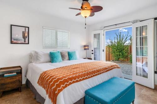 a bedroom with a bed and a ceiling fan at Haven Rock- Secluded Oasis and Sanctuary Gardens in Joshua Tree