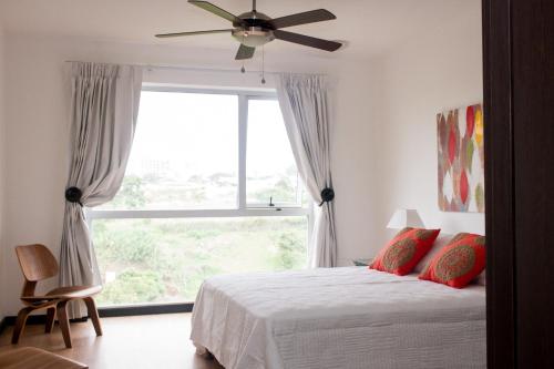 a bedroom with a bed and a large window at Charming two bedroom apartment in San José