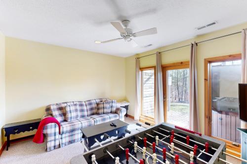 a living room with a couch and a table at Slopeslide Lakehouse in McHenry