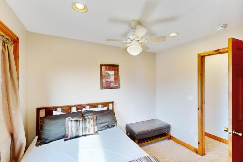 a bedroom with a bed and a ceiling fan at Slopeslide Lakehouse in McHenry