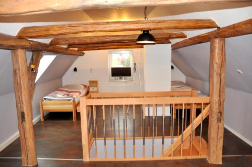 a attic room with a staircase and a bed at Ferienhaus Am Mühlenberg Thale Westerhausen in Thale