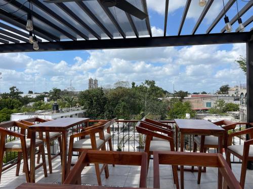 a group of tables and chairs on a balcony at Margarett Hotel in Valladolid