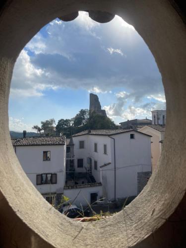 a view of a city through a round window at Al Piccolo Borgo Locanda Con Alloggio in Castelnuovo Parano