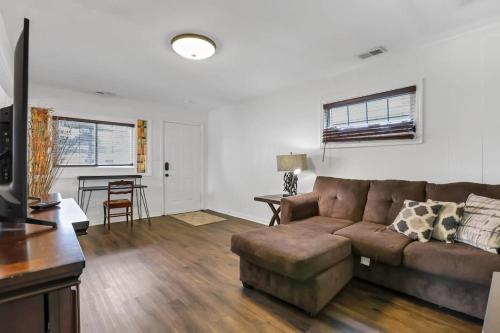 a living room with a couch and a table at Housepitality - The Southern Orchards Cottage in Columbus