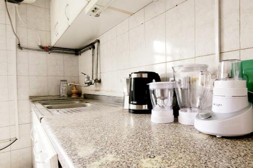 a kitchen with a counter with two blenders on it at A Spacious 4BR 2 Bathroom Villa House @ Bole DT in Addis Ababa