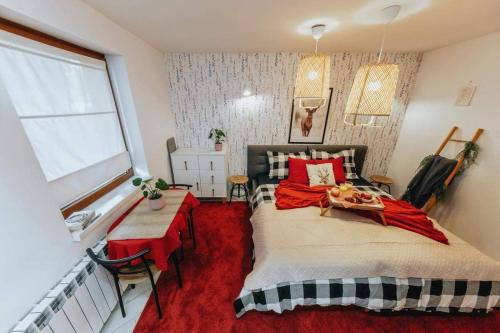 a bedroom with a large bed and a window at Kresy Wschodnie in Okszów