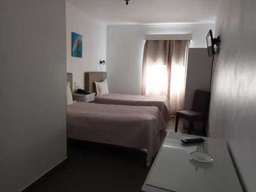 A bed or beds in a room at Hotel Branco I