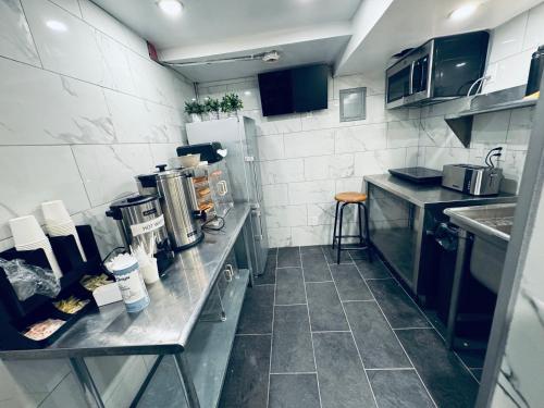 a small kitchen with a counter and a sink at KAMA CENTRAL PARK in New York