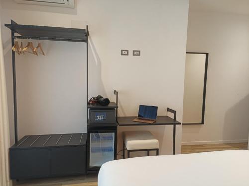 a bedroom with a desk with a laptop on it at Romi Suite in Rome