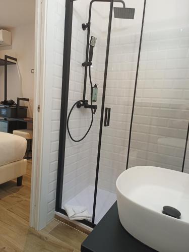 a bathroom with a shower and a white sink at Romi Suite in Rome