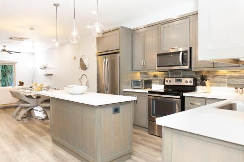 a kitchen with stainless steel appliances and a counter top at Garden Oasis 1 Villa With Private Pool in Four Roads
