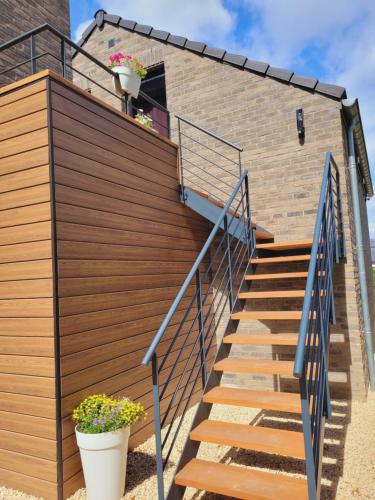a set of stairs leading up to a house at Studio 4 pers avec balcon et jardin in Sprimont