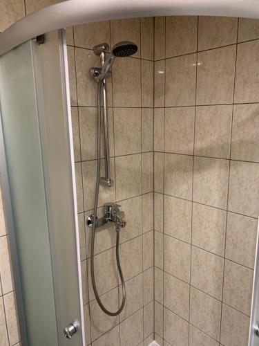 a shower with a shower head in a bathroom at DIKOL Two-Room Apartment-SELF CHECK-in & FREE Parking Near City Center in Tallinn