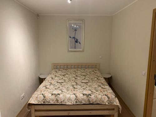 a bedroom with a bed with a flowery bedspread at DIKOL Two-Room Apartment-SELF CHECK-in & FREE Parking Near City Center in Tallinn