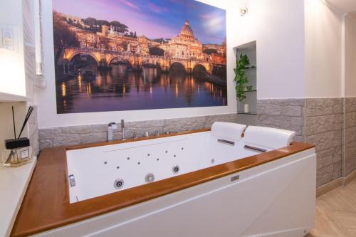 a bathroom with a bath tub with a painting on the wall at Deluxe Suite Welness in Rome