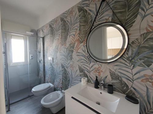 a bathroom with a sink and a mirror at CASA AL MARE LUXURY in Bari